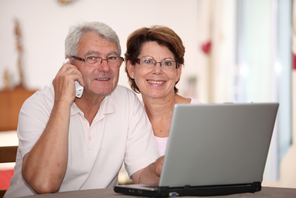 Senior,Couple,At,Home,With,Laptop,Computer